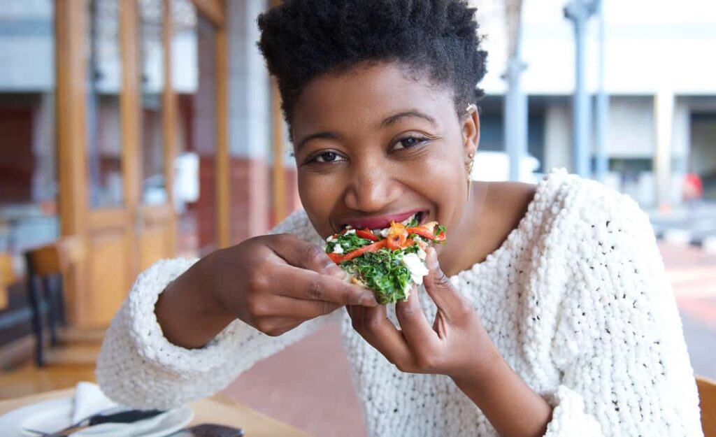 black woman eating happy
